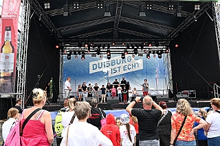 HDKSommerBiwak 2024-07-21 06  HDK Sommerbiwak 2024 - Pünktlich um 11.11 Uhr startete das 7. Sommerbiwak vom Hauptausschuss auf der Hauptbühne beim Duisburger Stadtfest zwischen City Palais und Forum. Die Akteure   im unterhaltsamen Programm, die Stark Reduzierte Einzelstücke, ⁠Lonnie & Friends von den Jungpiraten, die designierte Kinderprinzencrew 2024/25, ⁠Annika (Solo-Mariechen der KG Marxloher Jecken), die Kölner Band „⁠Miljö“ , wir die designierte Prinzencrew 2024/25 mit Holger II. und ⁠Philipp Godart. Für musikalische Untermalung sorgte das DJ Duo Schwarzwaldzimmer. : DVPJ, Holger II, Phil II., Prinz Karneval, Prinz, Prinzessin Mia I., Hofmarschälle, Page, Pagen, Paginnen, HDK, Duisburg, Karneval, Helau, Tollität, Event, Session 2024, Session 2025, HDK Duisburg, Hauptausschuss, Hauptausschuss Karneval Duisburg, Duisburg ist echt